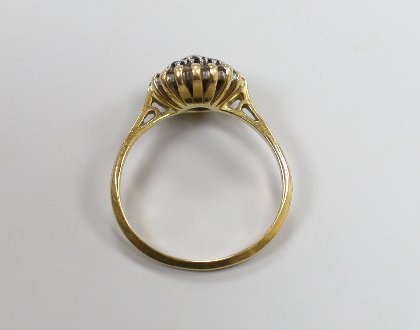 A 1960's 18ct gold, sapphire and diamond set circular cluster ring, size O, gross weight 3.7 grams.